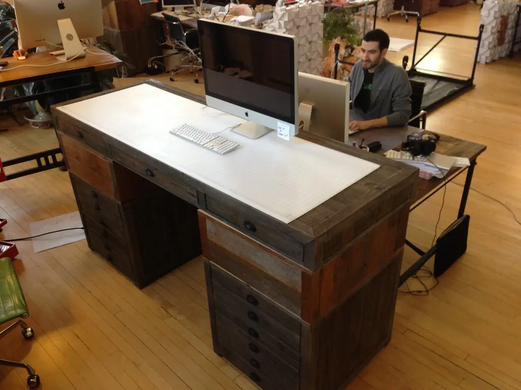 Standing desk workstation in an office interior